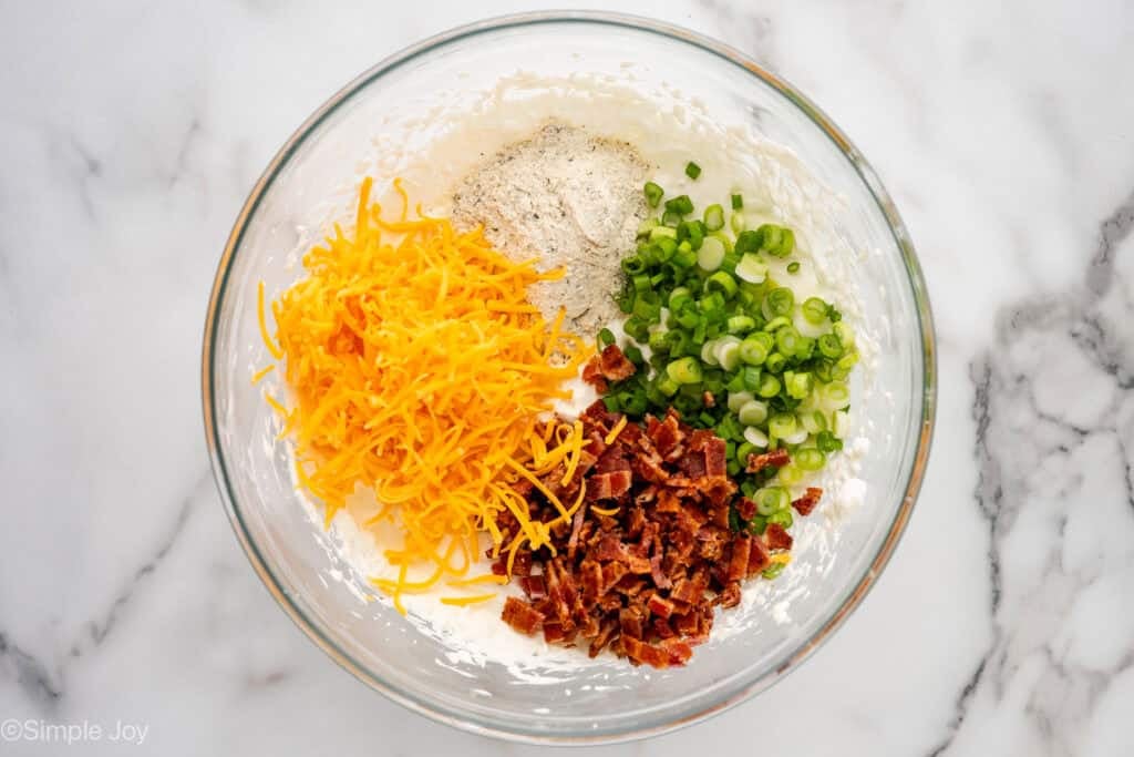 Overhead of glass bowl of crack dip ingredients