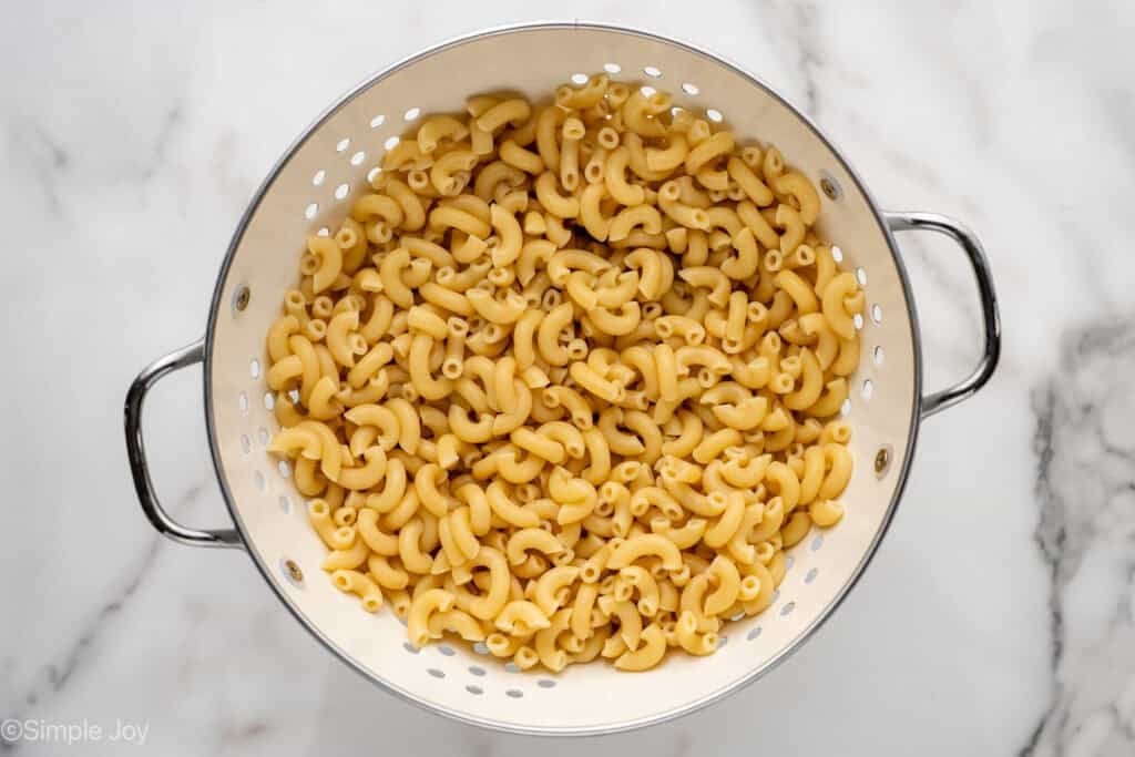 Overhead of colander of cooked pasta to make Deviled Egg Pasta Salad