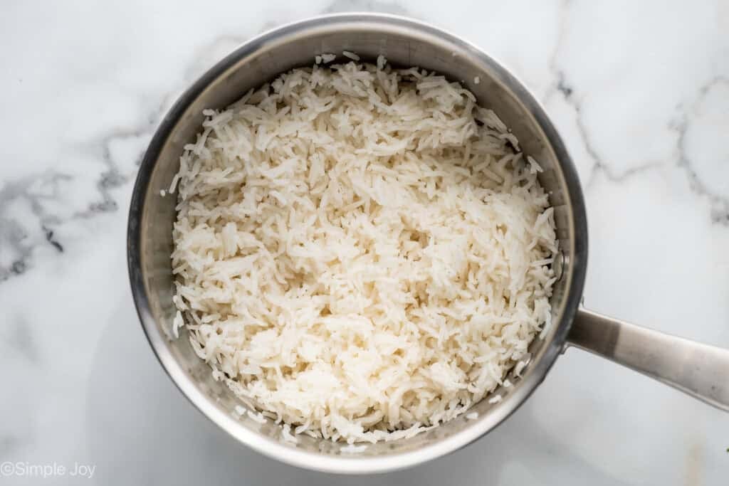 Overhead of saucepan of cooked white rice to make Honey Sriracha Chicken Bowl