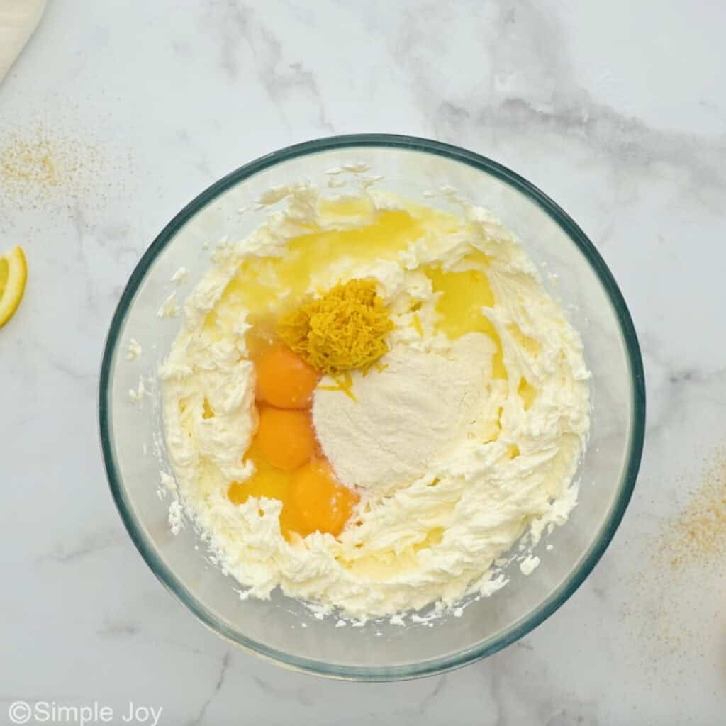 Overhead of glass bowl of lemon cheesecake filling ingredients