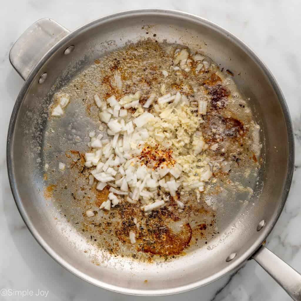 Overhead of skillet of One Pot Lemon Chicken and Orzo ingredients