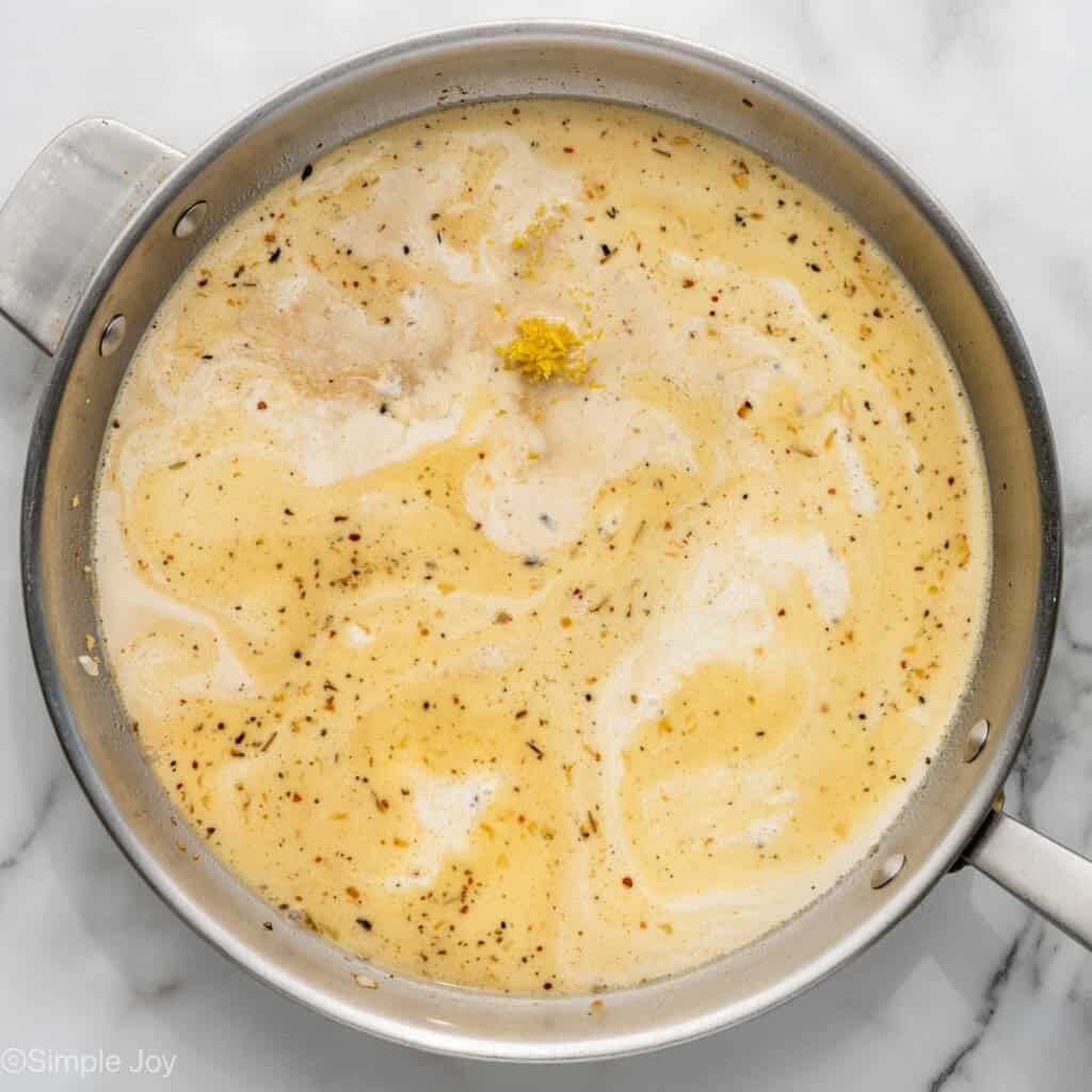 Overhead of skillet of One Pot Lemon Chicken and Orzo ingredients
