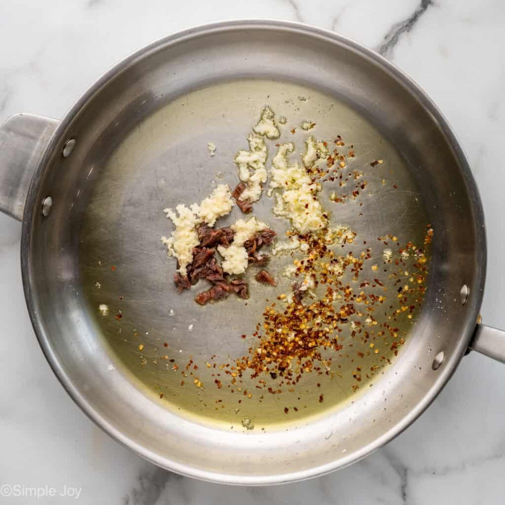 Overhead of skillet of Pasta Puttanesca ingredients