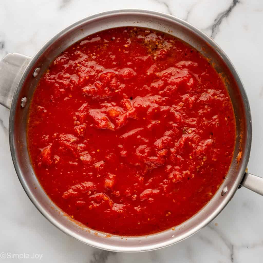 Overhead of skillet of Pasta Puttanesca ingredients