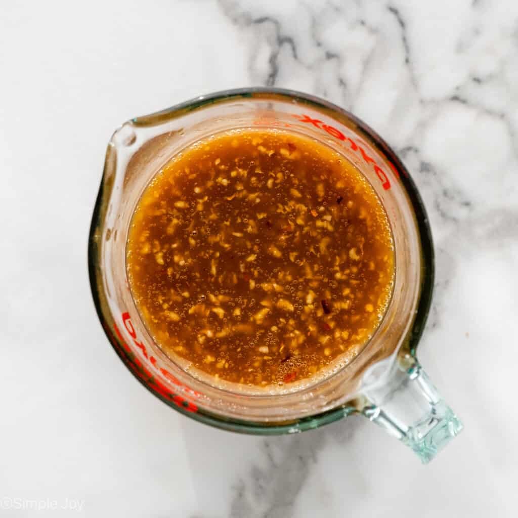 Overhead of glass measuring cup of Honey Garlic Chicken and Vegetables recipe ingredients