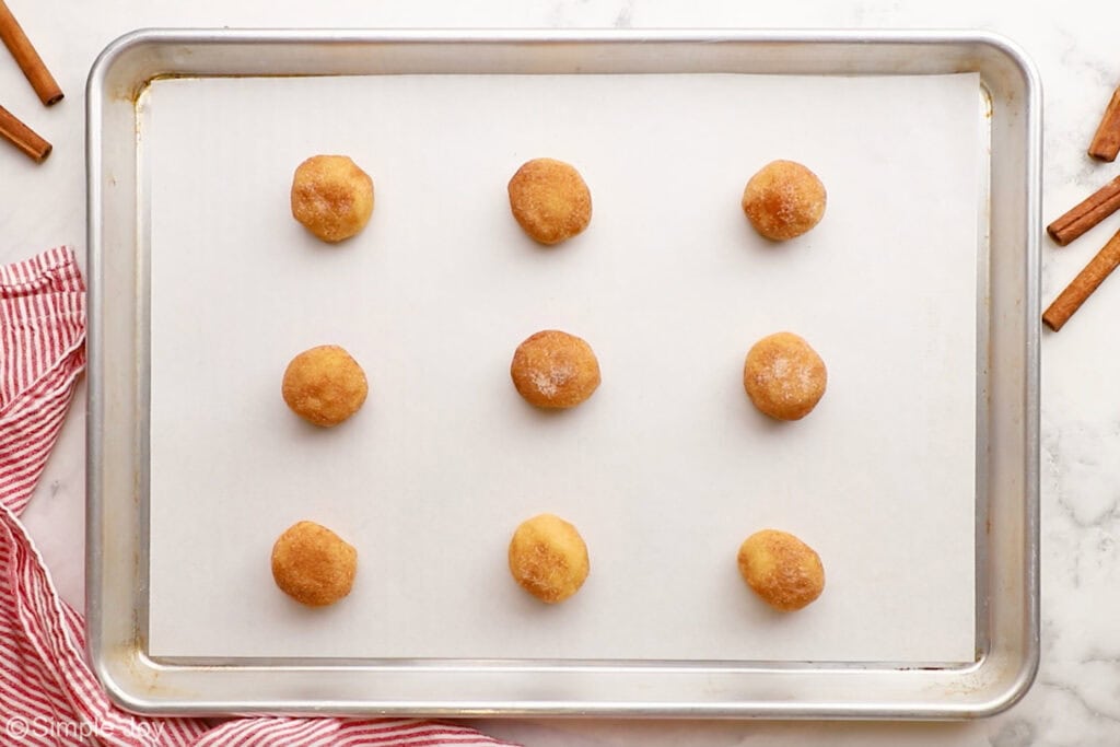 Overhead of Snickerdoodle cookie dough balls on a baking sheet