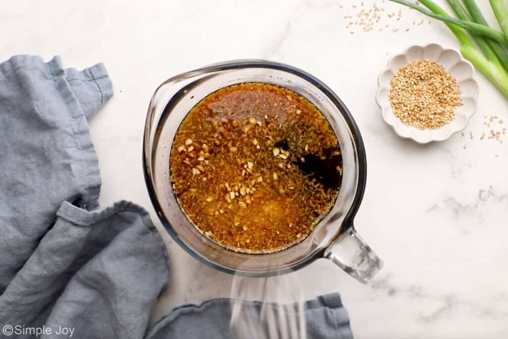 Overhead of glass measuring cup of teriyaki sauce ingredients to make teriyaki salmon