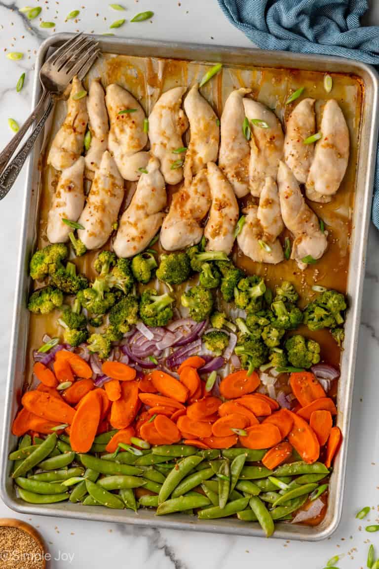 Overhead of sheet pan Honey Garlic Chicken and Vegetables with two forks
