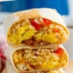 Pinterest graphic for Breakfast Burrito recipe. Says "the best Breakfast Burritos simplejoy.com" Image shows three Breakfast Burritos stacked on top of each other