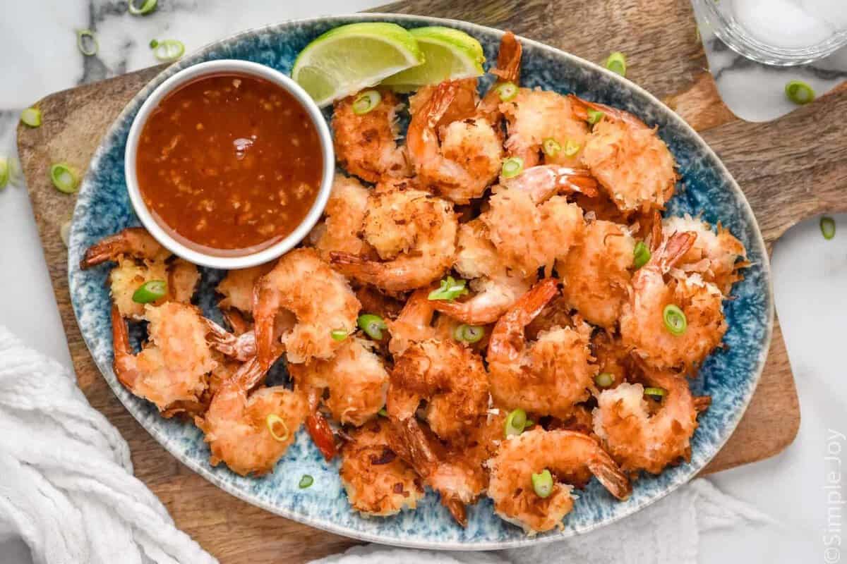 Overhead view of platter of Coconut Shrimp and chili sauce