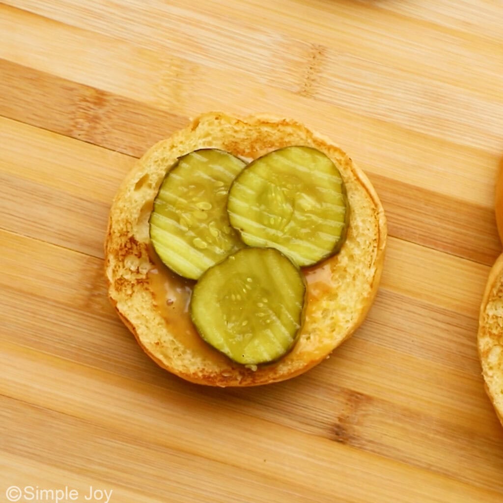 Overhead of bun with chik fil a sauce and sliced pickles to make homemade chicken sandwich recipe