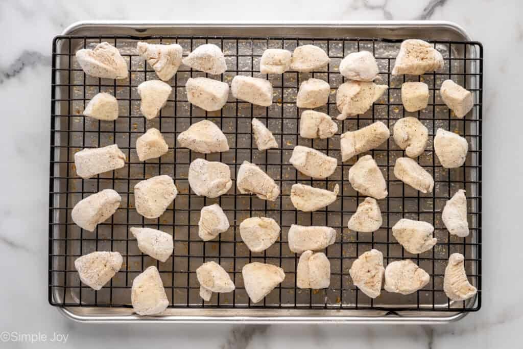 Overhead of Baked Orange Chicken ingredients on a wire rack over a baking sheet