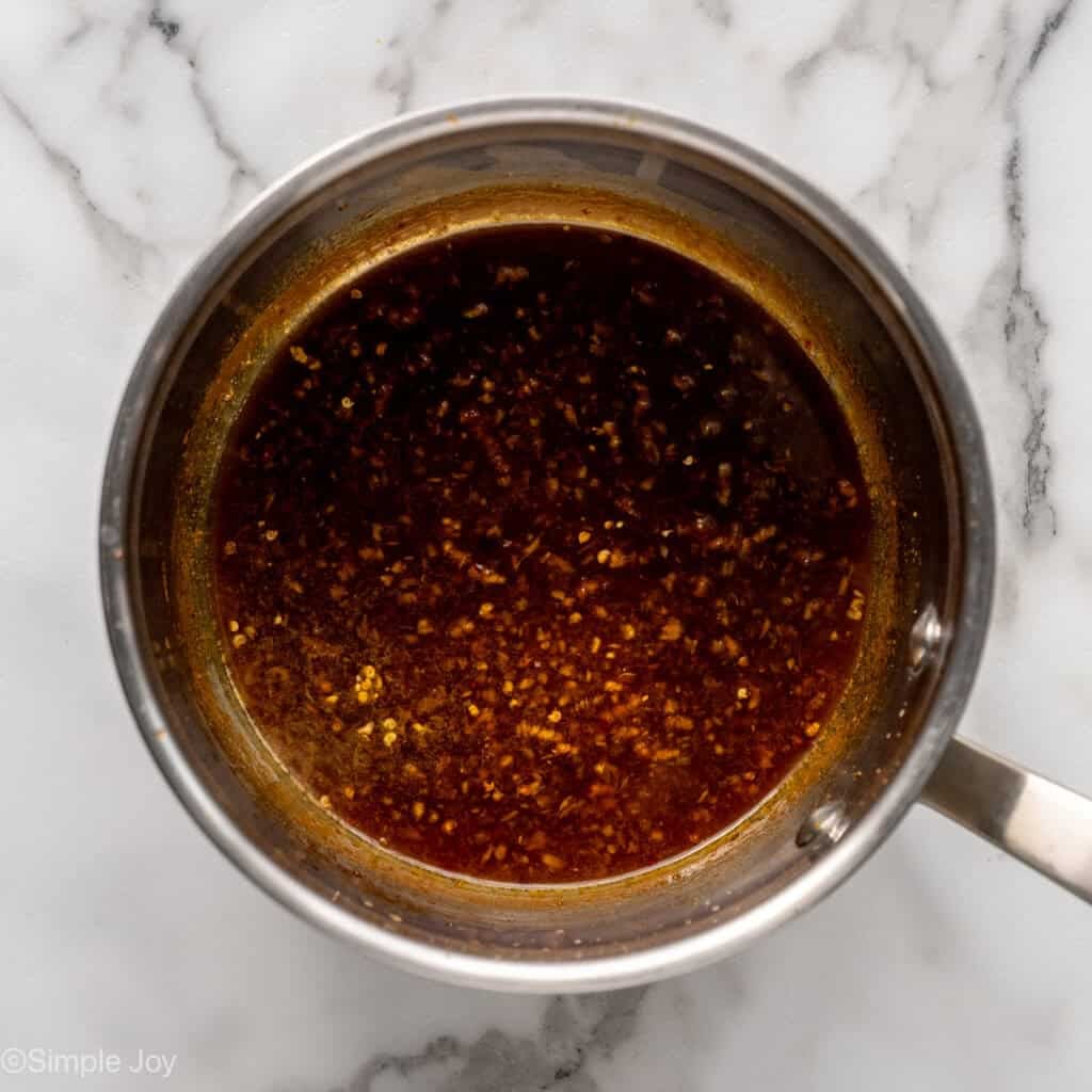 Overhead of saucepan with orange chicken sauce ingredients to make baked orange chicken