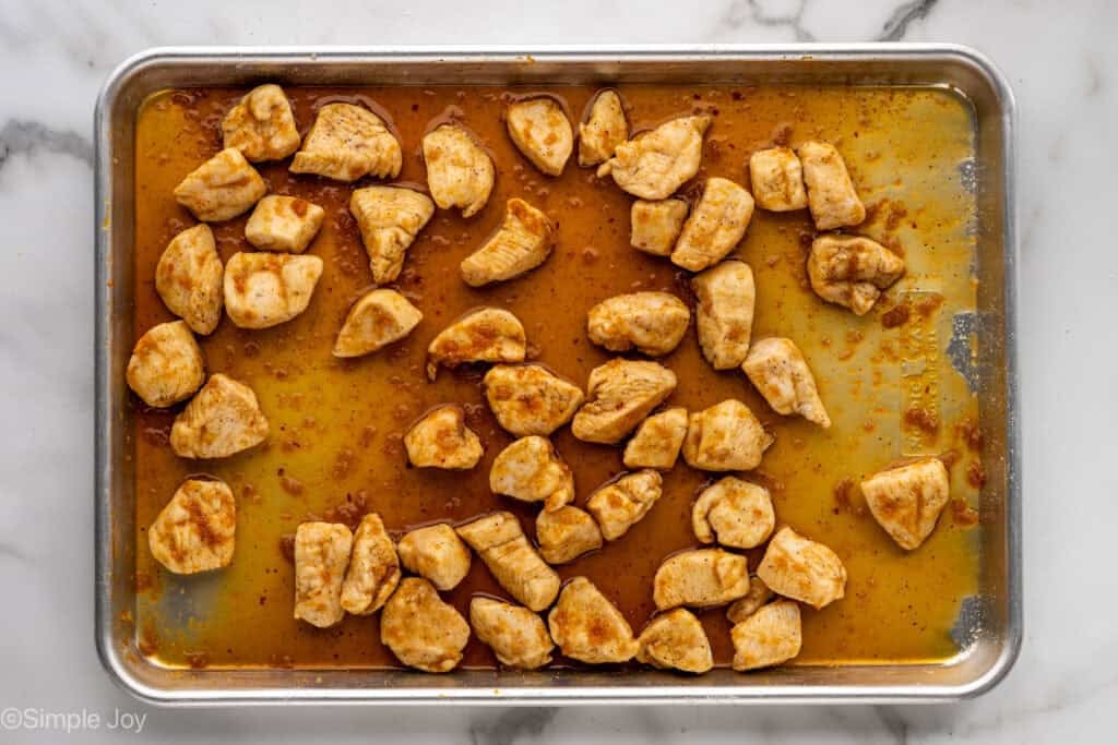 Overhead of baking sheet of baked orange chicken