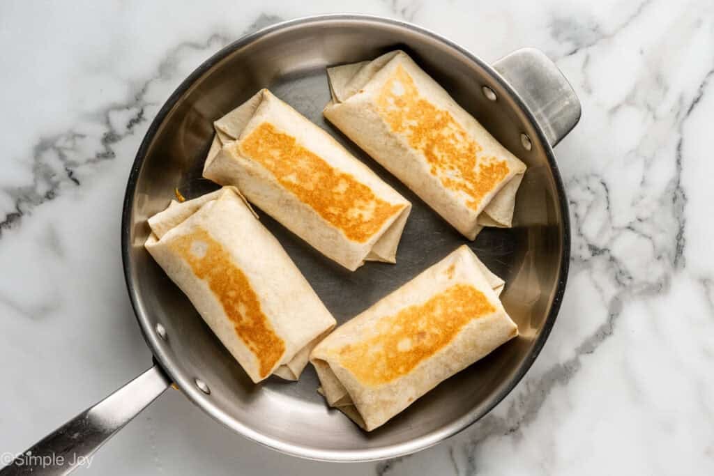 Overhead of skillet of breakfast burritos
