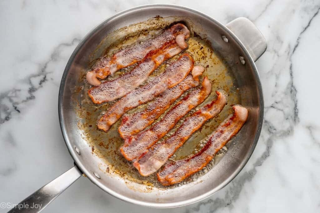 Overhead of skillet of bacon cooking to make Breakfast Burritos