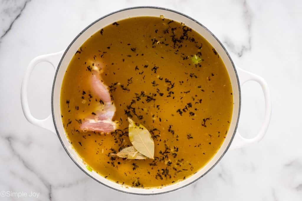 Overhead of large stock pot of chicken and rice soup ingredients