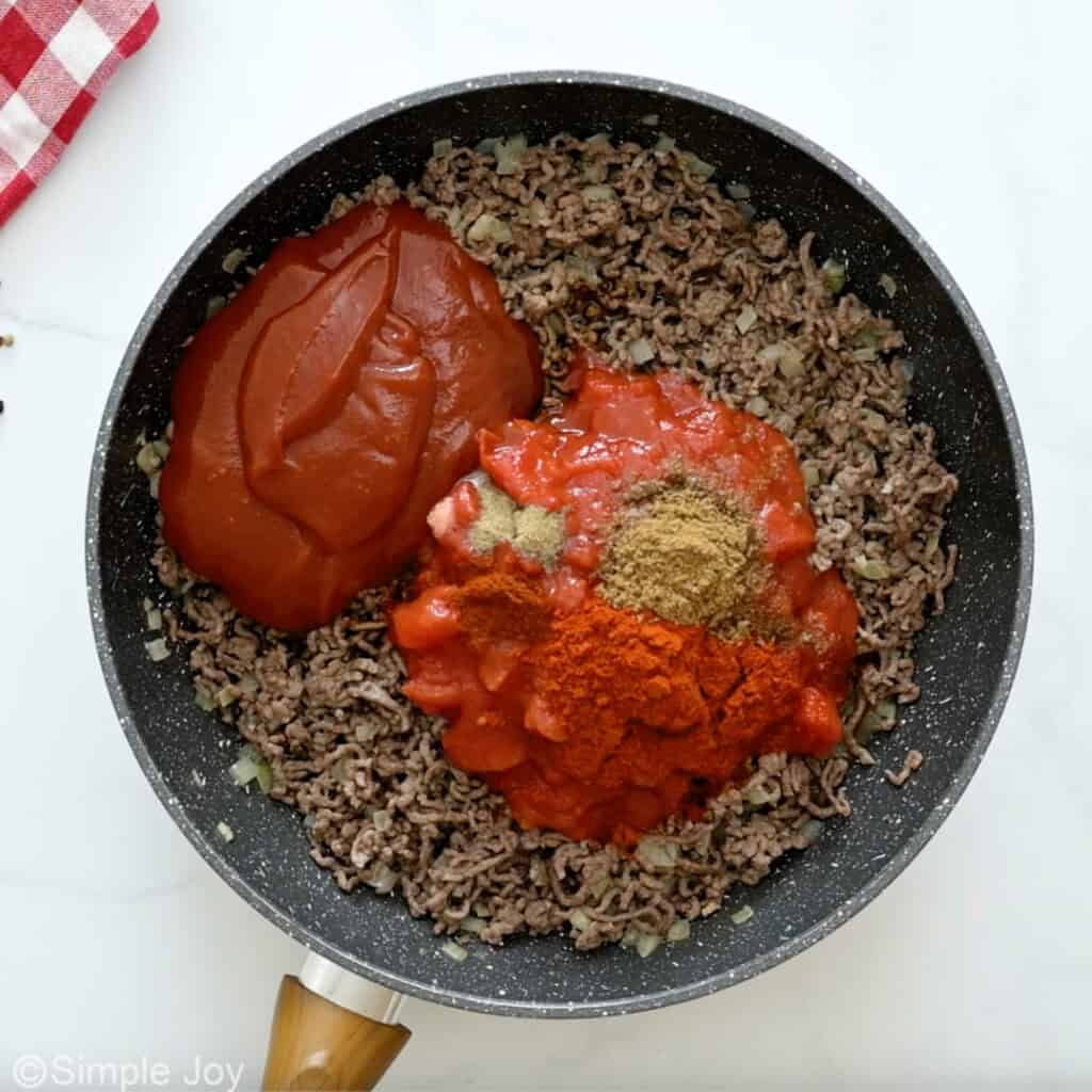 Overhead of skillet of chili dog ingredients