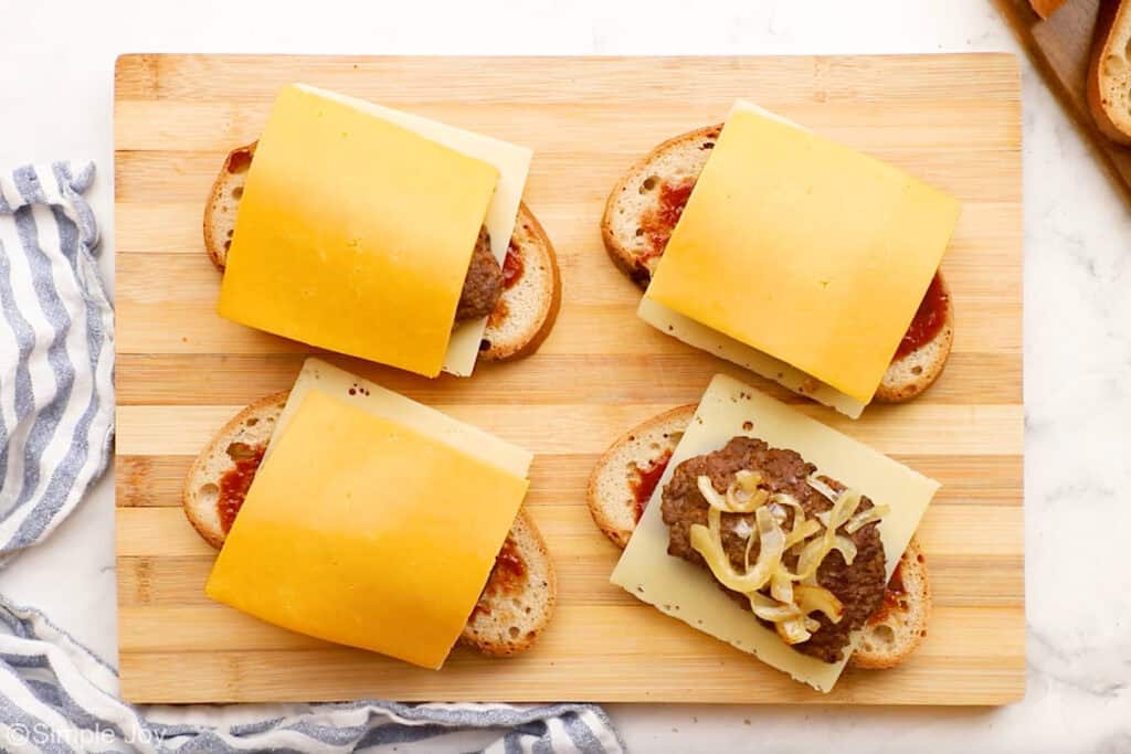 Overhead of patty melt ingredients on a wooden cutting board