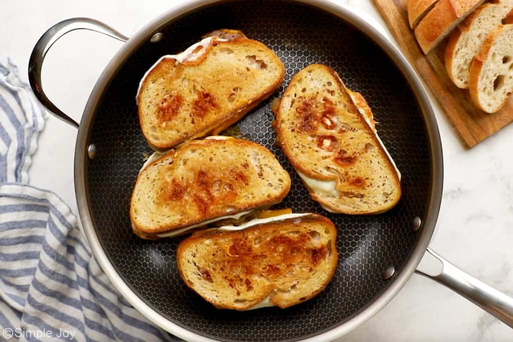 Overhead of 4 patty melts in a skillet