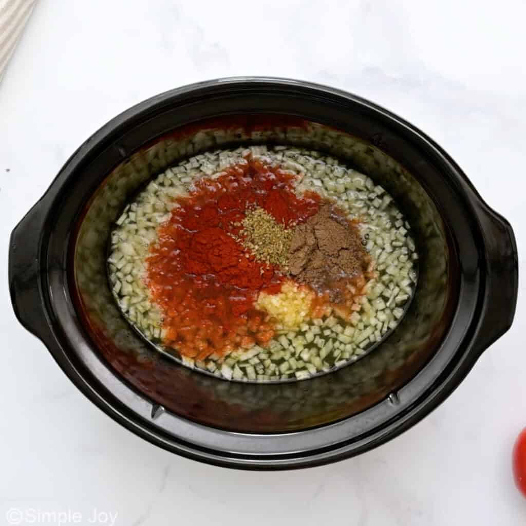 Overhead of slow cooker of ingredients to make slow cooker carnitas