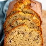 Pinterest graphic for banana bread. Says "the best banana bread recipe simplejoy.com" Image shows slices of banana bread on a wooden board