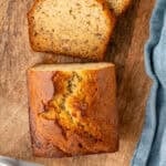 Pinterest graphic for banana bread. Image shows overhead of loaf and slices of banana bread on wooden board. Says "super easy banana bread simplejoy.com"