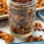 Pinterest graphic for granola recipe. Image shows jar of homemade granola with granola sitting beside and in background. Says "granola recipe simplejoy.com"