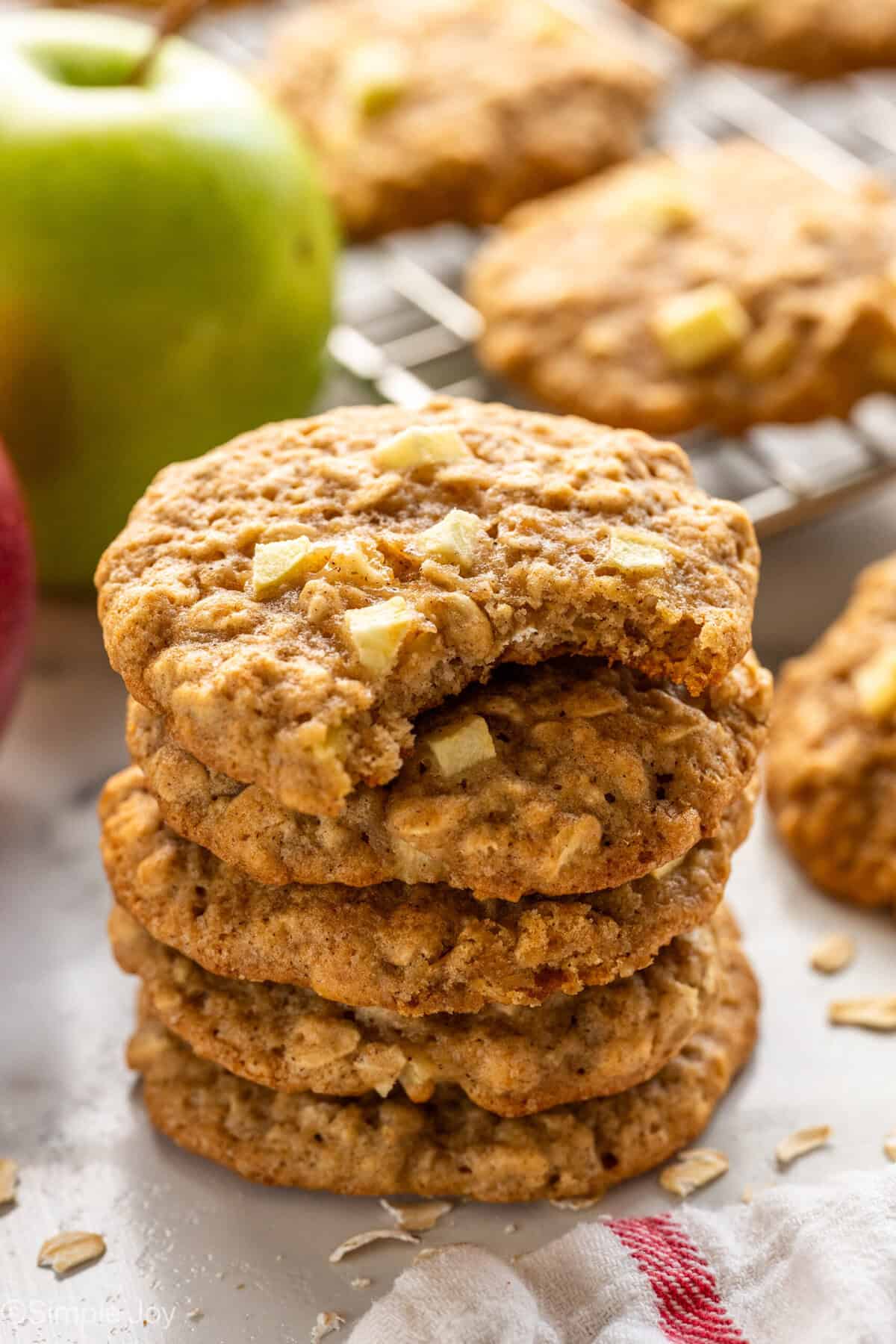 Stack of apple cookies with green apple and apple cookies in background