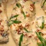 Overhead of Crockpot Marry Me Chicken garnished with fresh basil leaves