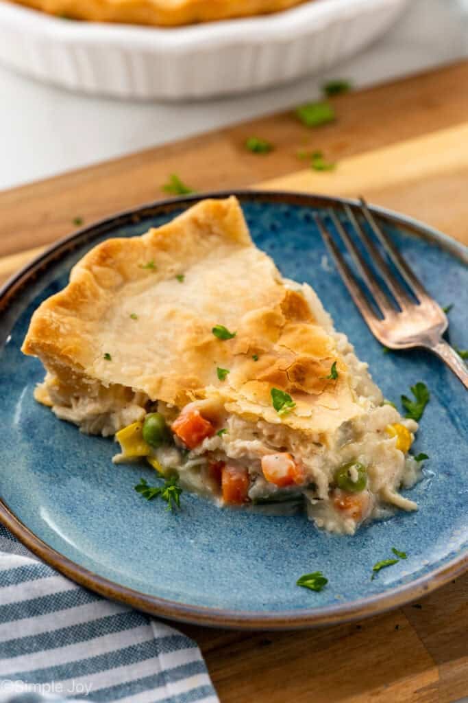 Piece of easy chicken pot pie on a plate with fork sitting beside