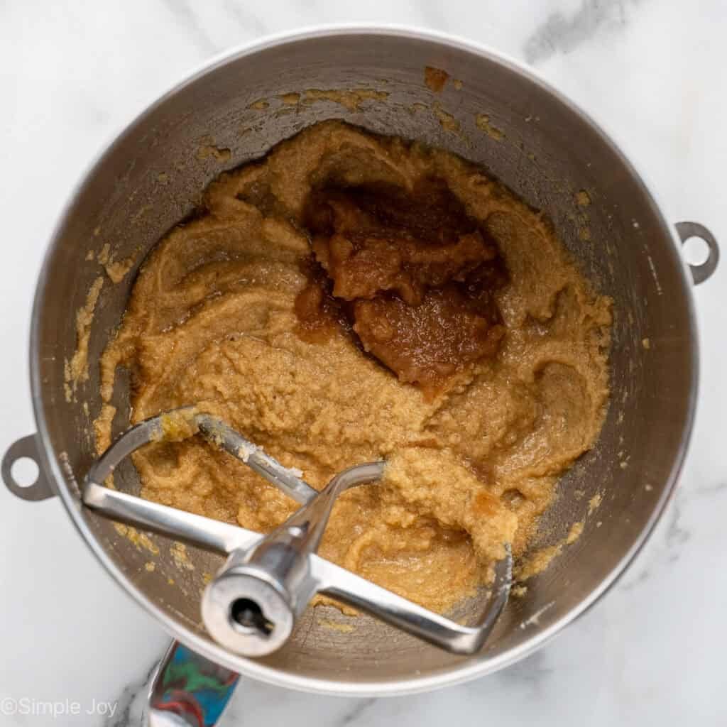Overhead of apple cookie ingredients in a mixing bowl with paddle attachment