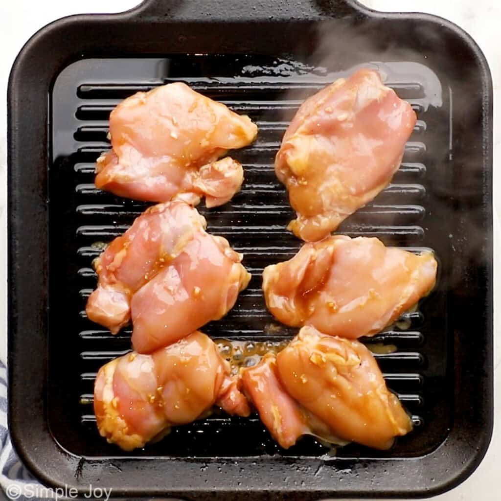 Overhead of chicken thighs on a grill to make teriyaki chicken recipe