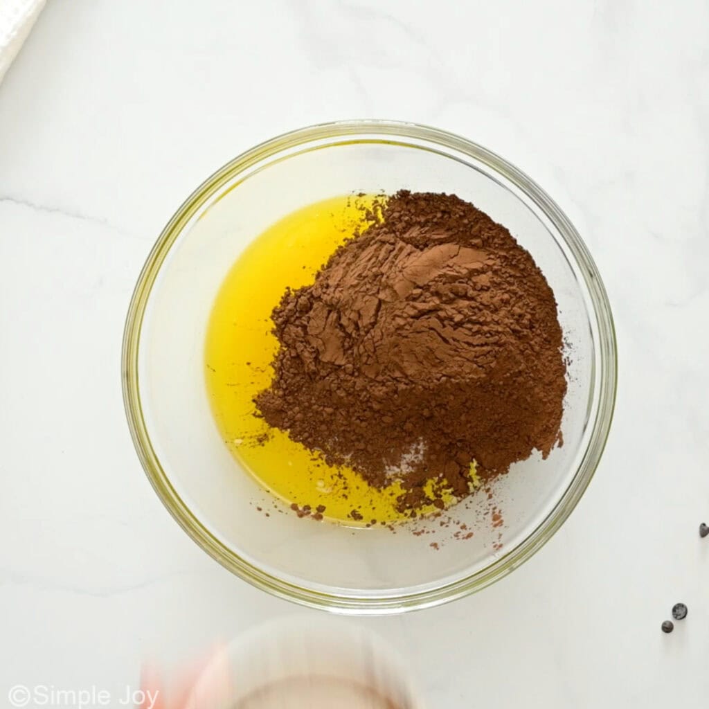 Overhead of glass bowl of ingredients for death by chocolate brownies