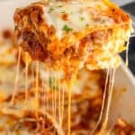 Piece of homemade lasagna being lifted out of pan