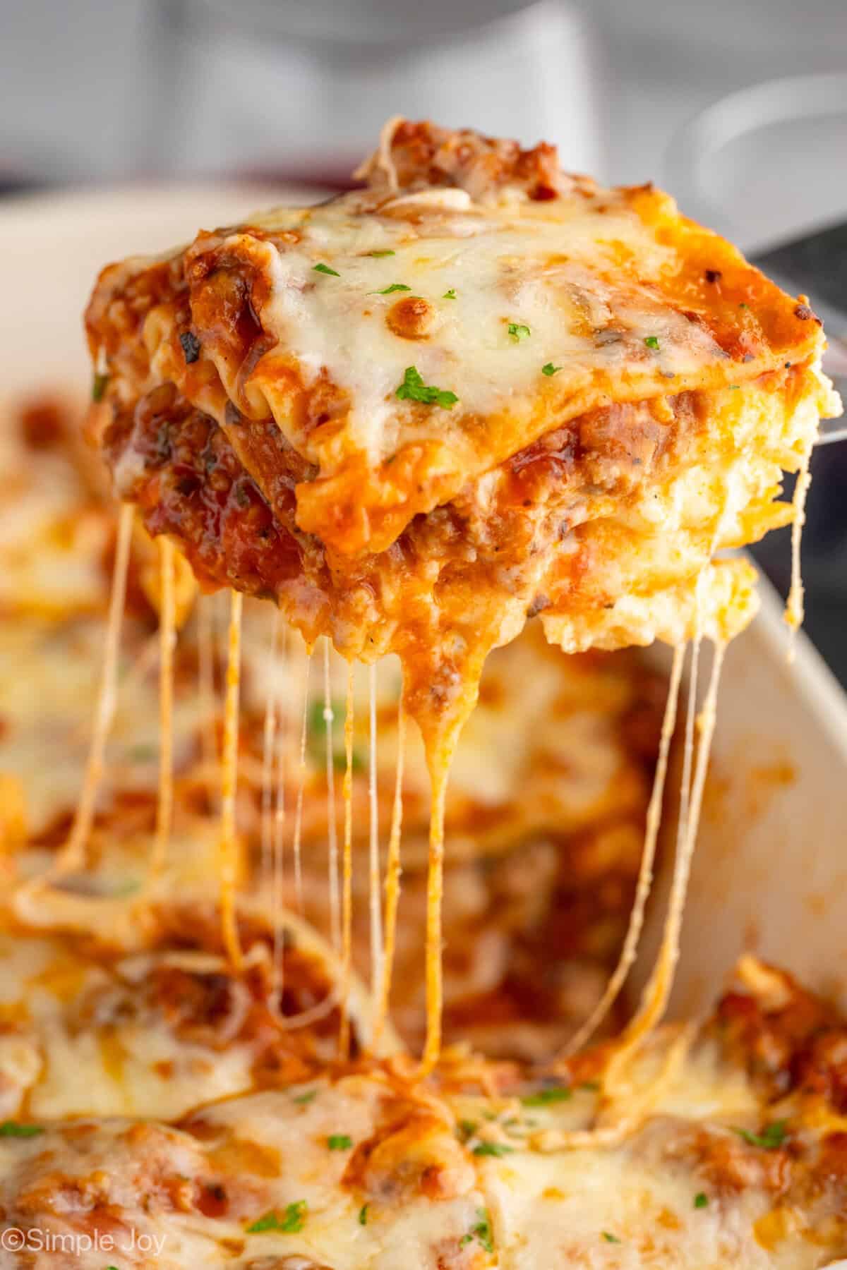 Piece of homemade lasagna being lifted out of pan