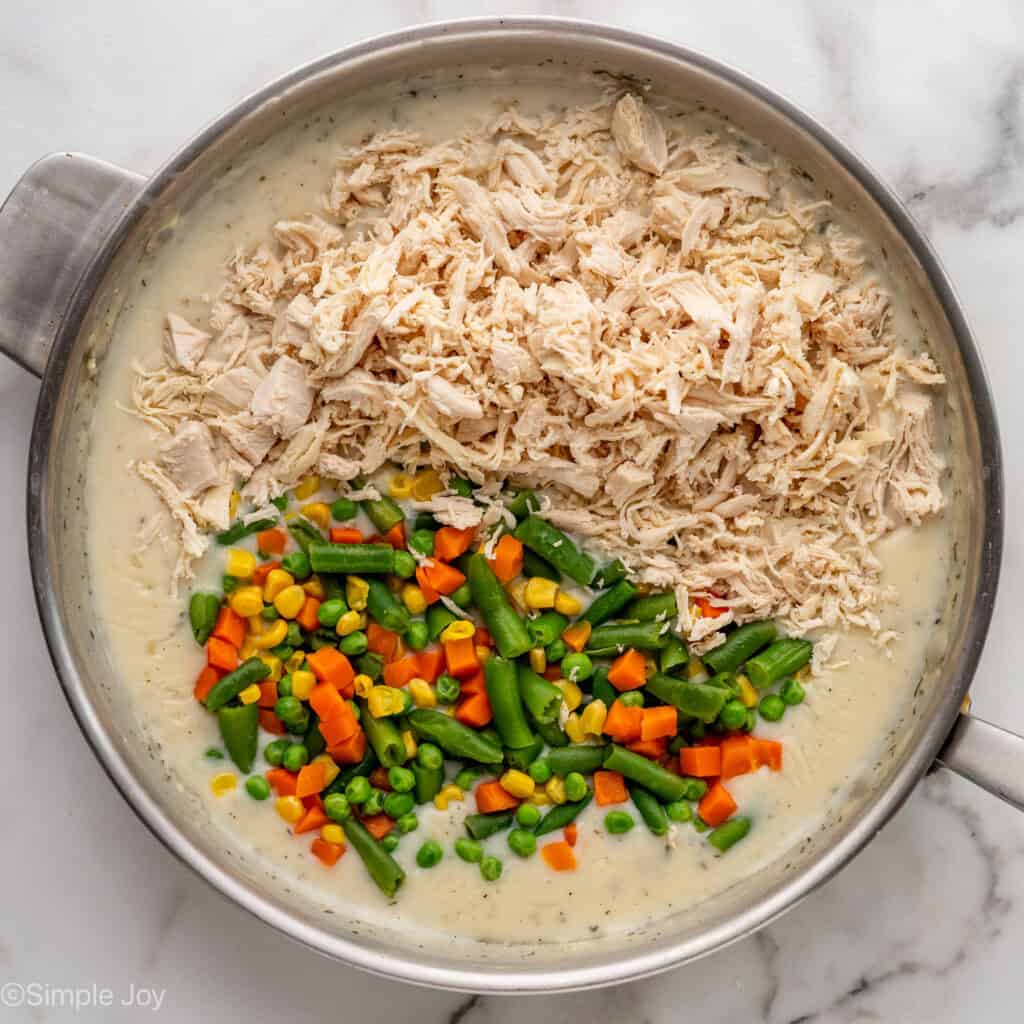 Overhead of skillet of easy chicken pot pie ingredients