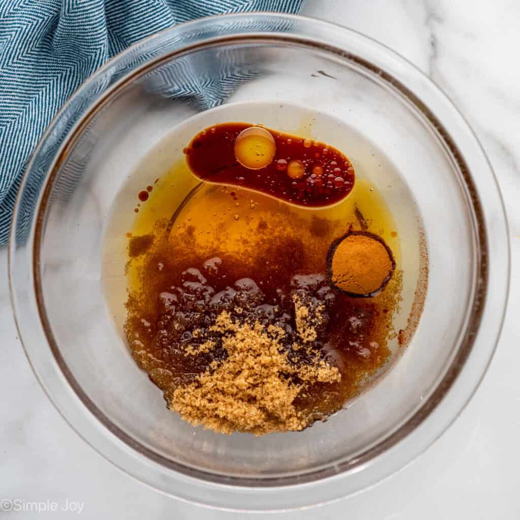 Overhead of glass bowl of granola ingredients