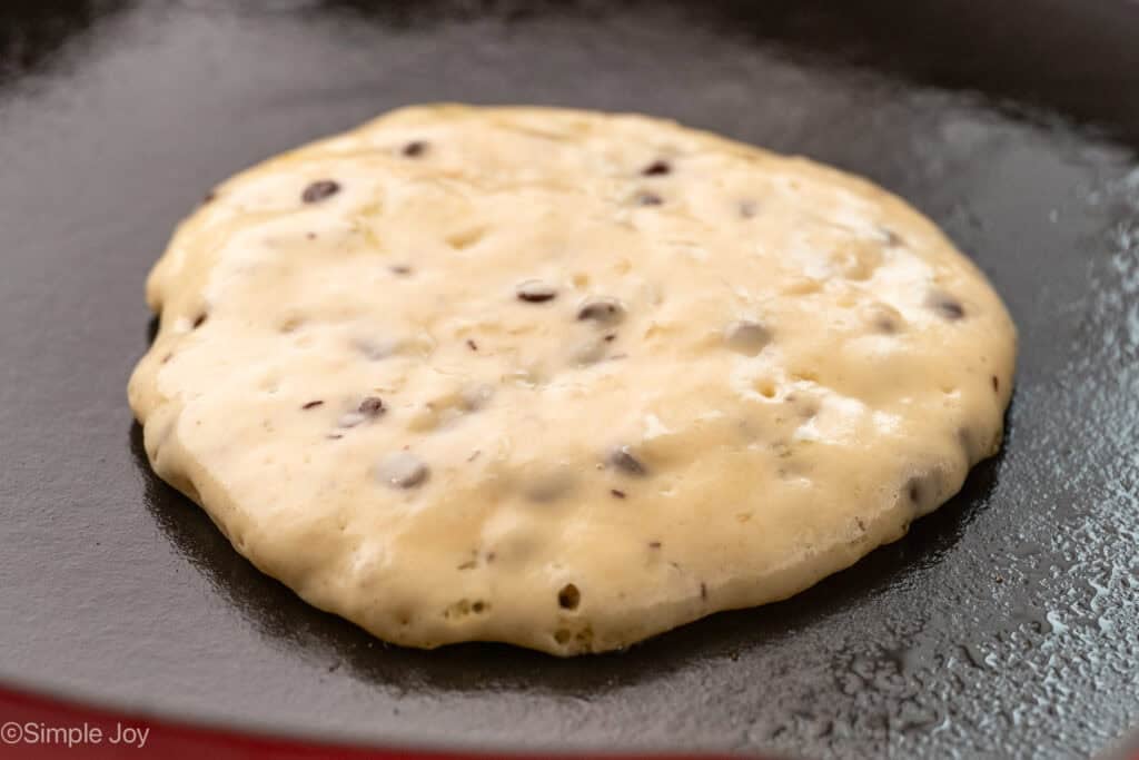 Chocolate chip pancake batter on a skillet