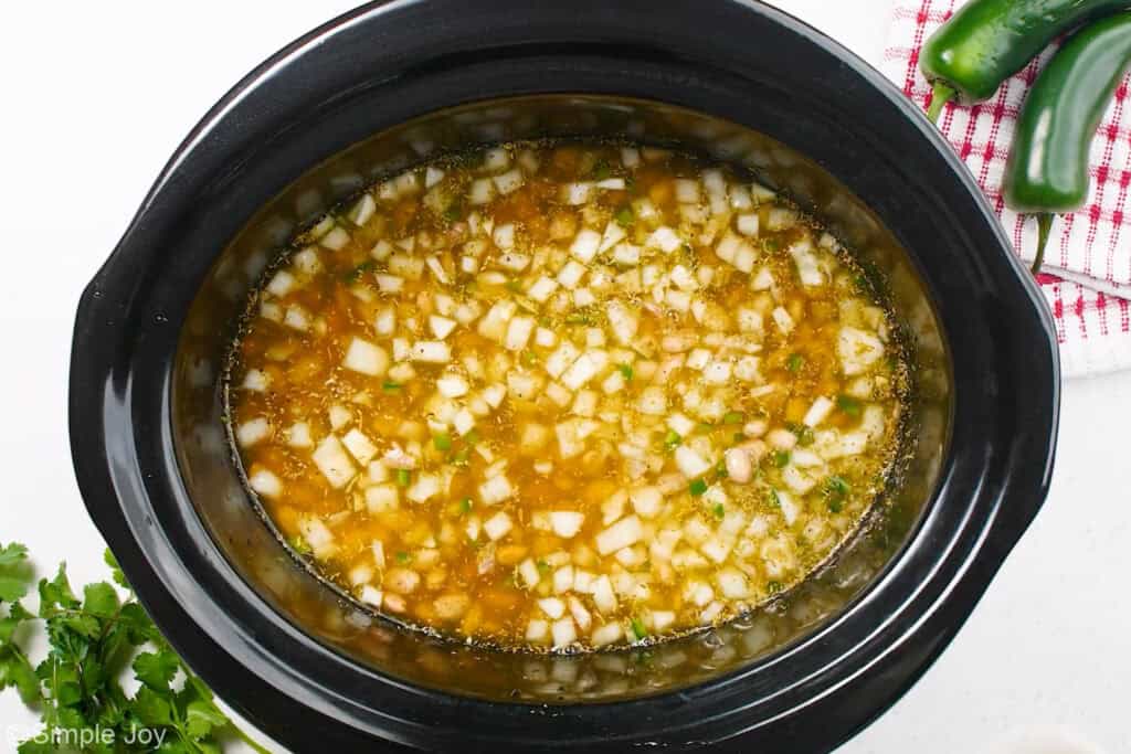 Overhead of slow cooker of pinto beans recipe ingredients