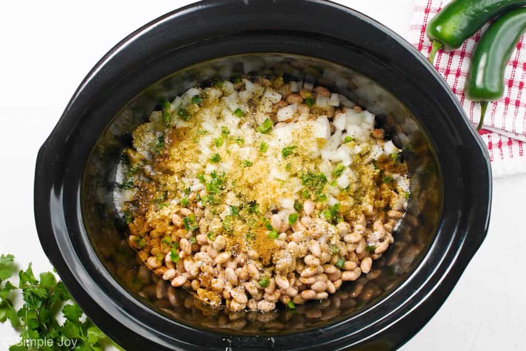 Overhead of slow cooker of pinto beans recipe ingredients