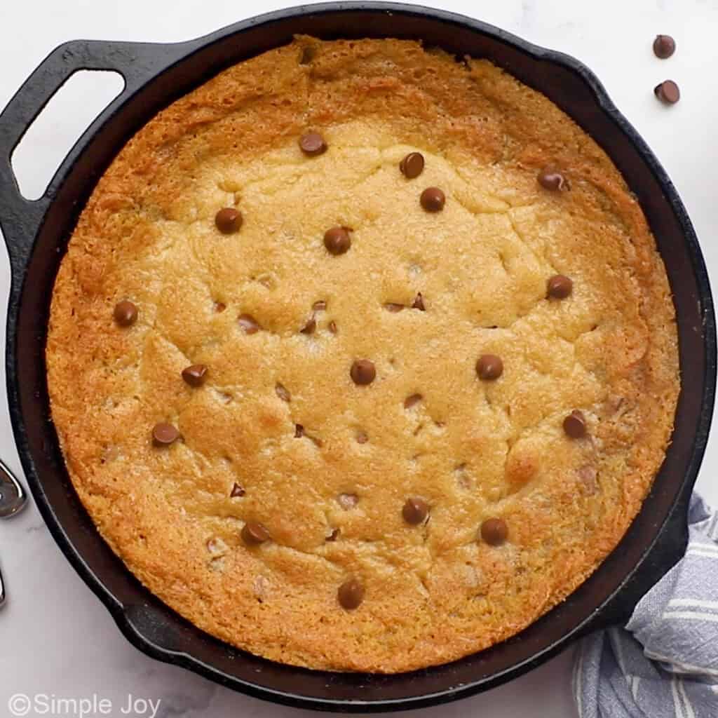 Overhead of cast iron skillet of pizookie, topped with chocolate chips