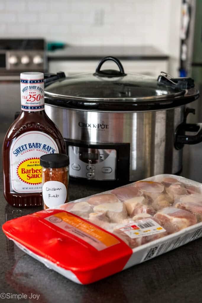 chicken drumsticks ingredients and a slow cooker sitting on kitchen counter
