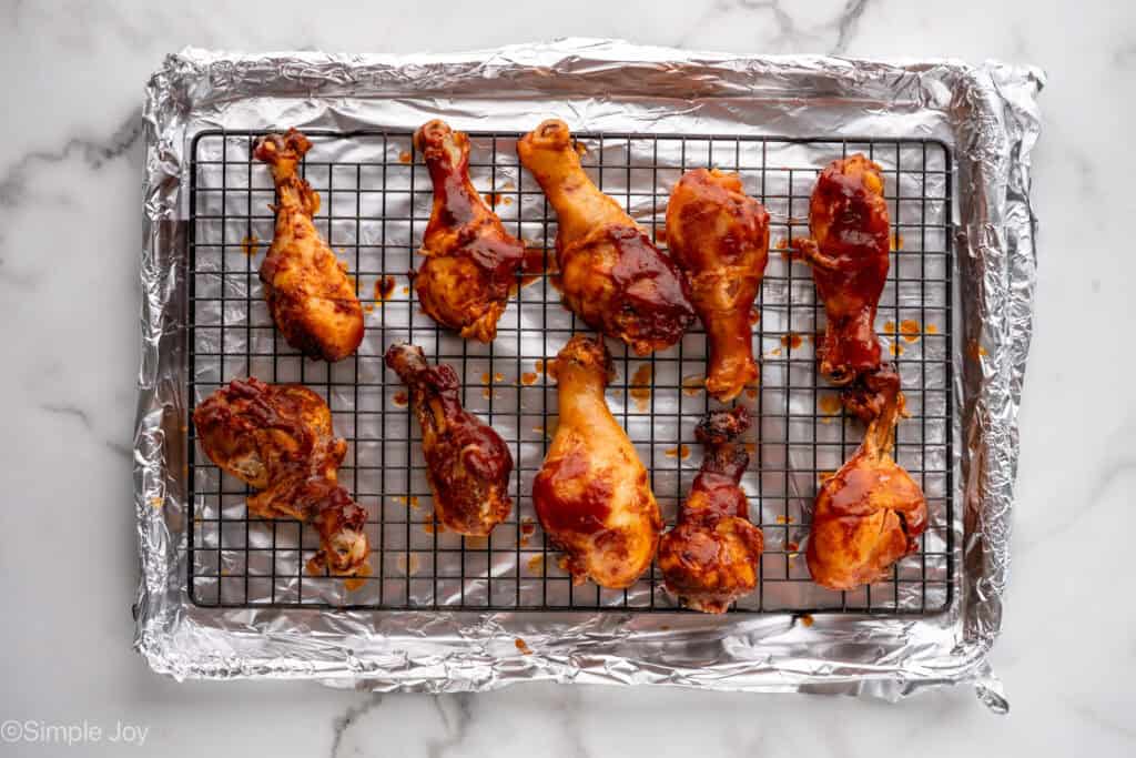 slow cooker chicken drumsticks on wire rack before broiling