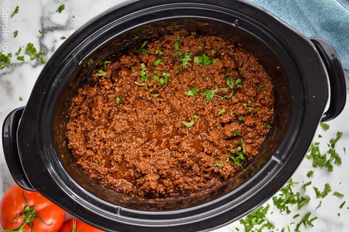 Overhead view of Slow Cooker Taco Meat in a crock pot garnished with cilantro
