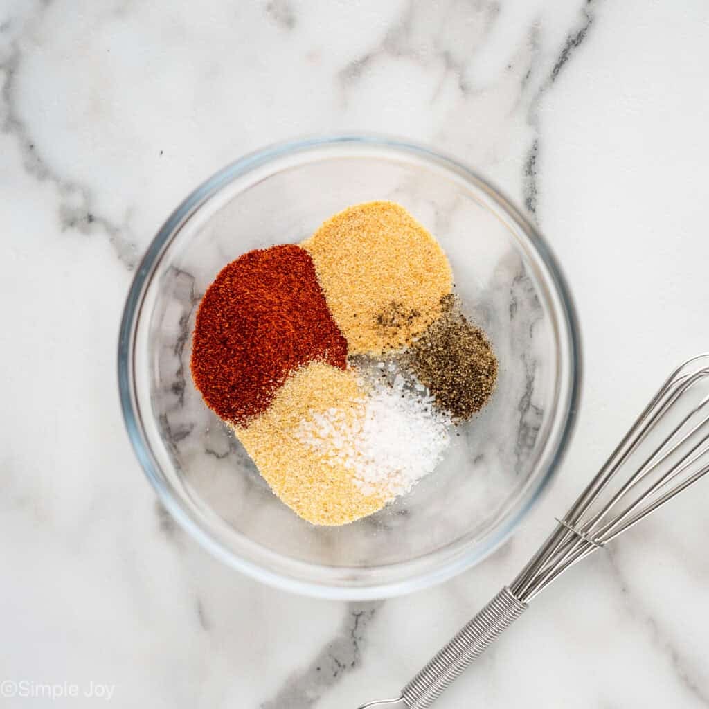Overhead of glass bowl of seasonings separated by ingredient