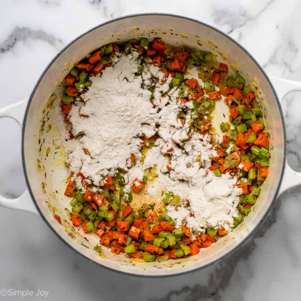 overhead of a dutch oven with sauteed vegetables and flour