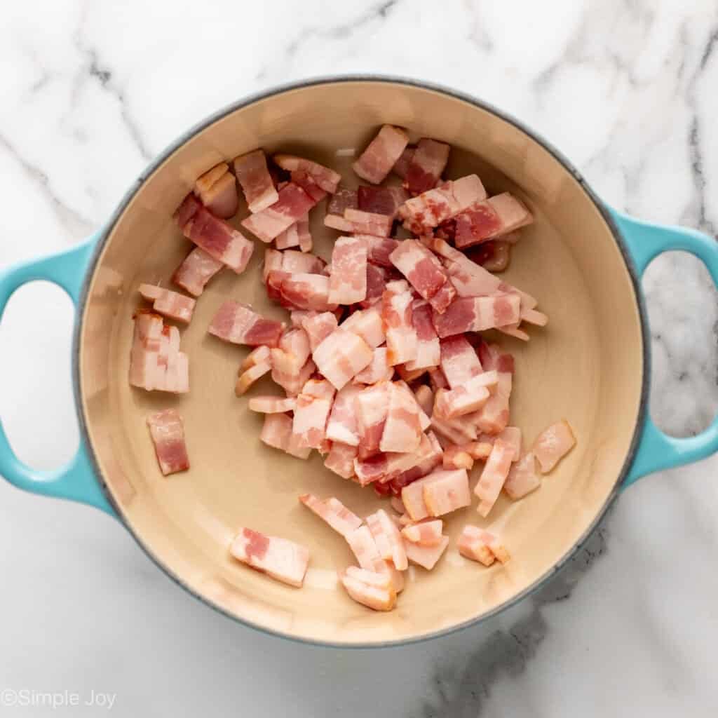 Overhead of pot of raw diced bacon
