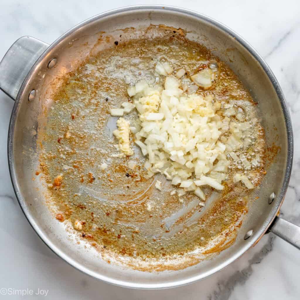 Overhead of skillet of onions and garlic to saute