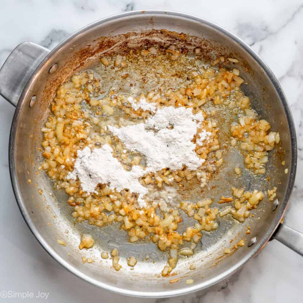Overhead of skillet of sauteed onions with flour